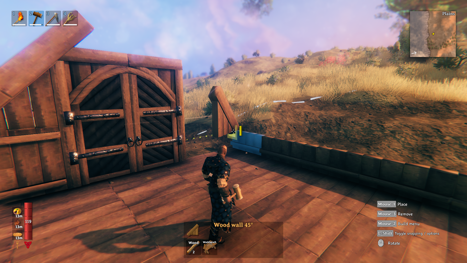 Valheim: a character holding a hammer while building a wooden house.